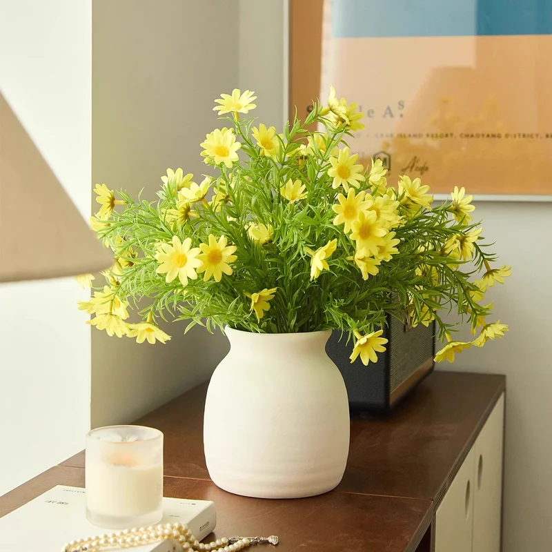 Minimalistische matte Keramikvase mit naturähnlichem Kunstgänseblümchenstrauß